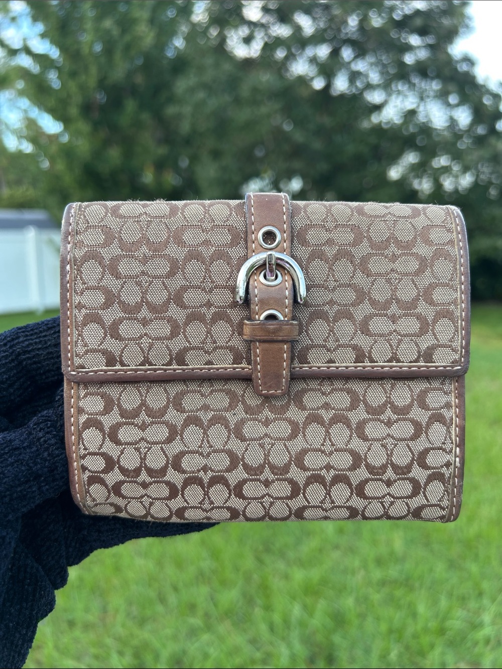 Coach signature bifold wallet with buckle accent